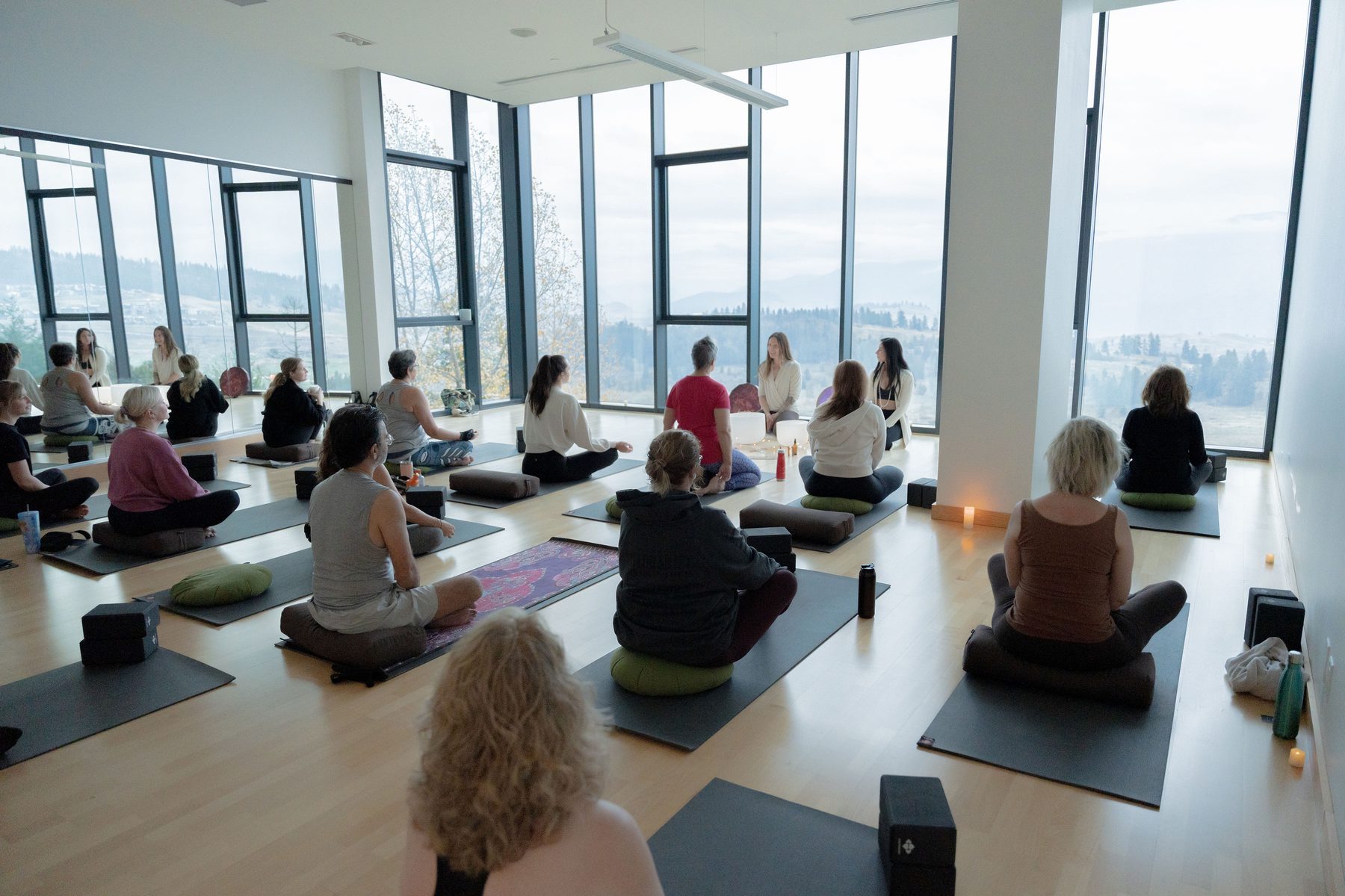 Group of women gathered in a circle at the yoga retreat with mountain views